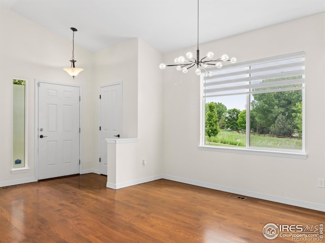 603 Summer Hawk Dr, Longmont, CO 80504 - foyer entrance with a chandelier, wood finished floors, baseboards, and vaulted ceiling