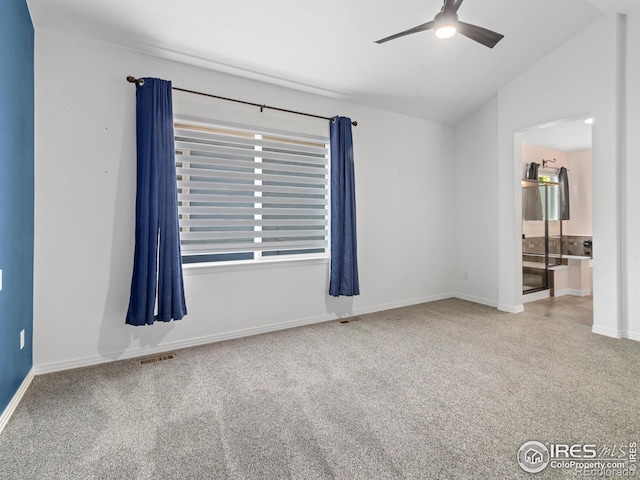 603 Summer Hawk Dr, Longmont, CO 80504 - spare room featuring ceiling fan, carpet, vaulted ceiling, and baseboards