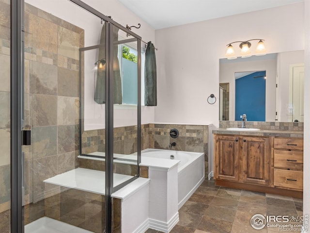 603 Summer Hawk Dr, Longmont, CO 80504 - bathroom with a garden tub, vanity, a shower stall, and stone finish flooring