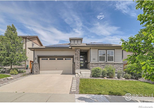 4343 E 96th Way, Thornton, CO 80229 - view of front of home with stone siding, concrete driveway, a garage, solar panels, and a front lawn