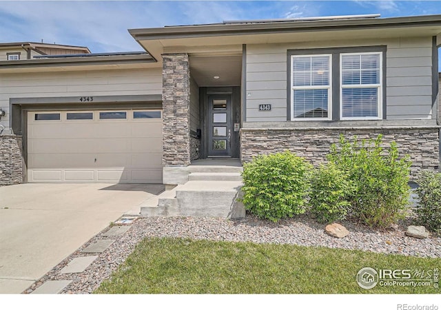 4343 E 96th Way, Thornton, CO 80229 - view of front of property with stone siding, driveway, and an attached garage