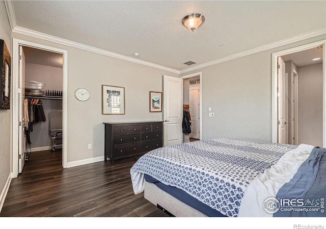 4343 E 96th Way, Thornton, CO 80229 - bedroom with dark wood-style flooring, crown molding, baseboards, a spacious closet, and a closet