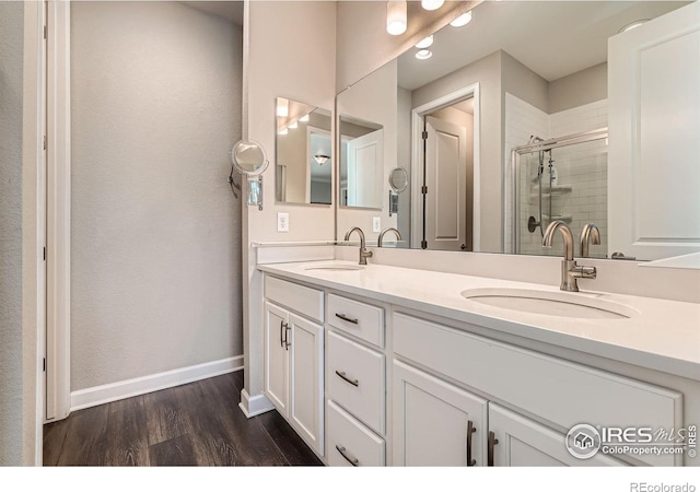 4343 E 96th Way, Thornton, CO 80229 - full bathroom with double vanity, wood finished floors, baseboards, and a stall shower