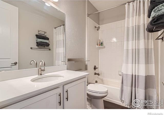 4343 E 96th Way, Thornton, CO 80229 - bathroom featuring toilet, vanity, shower / bath combo with shower curtain, and a textured wall