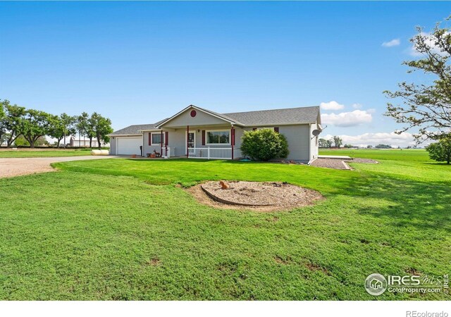 32924 County Road 29, Greeley, CO 80631 - ranch-style home featuring a porch, a garage, driveway, and a front lawn