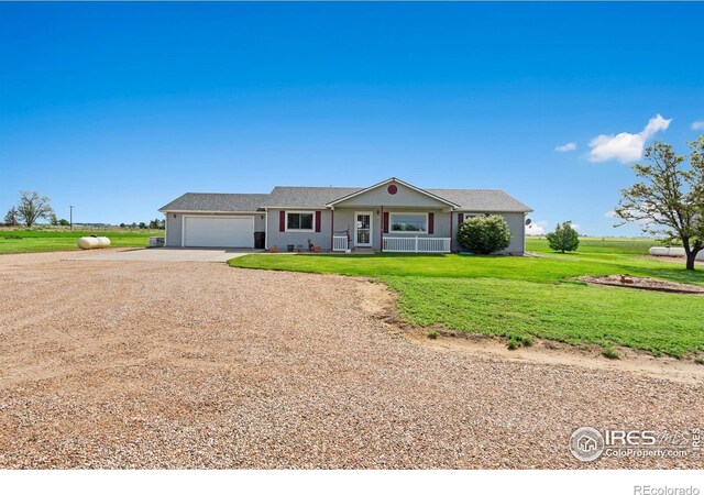 32924 County Road 29, Greeley, CO 80631 - ranch-style house with dirt driveway, an attached garage, a front yard, and a porch