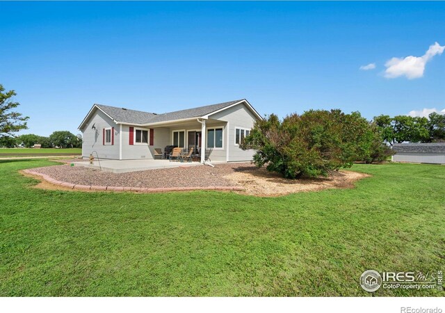 32924 County Road 29, Greeley, CO 80631 - back of house featuring a patio area and a lawn