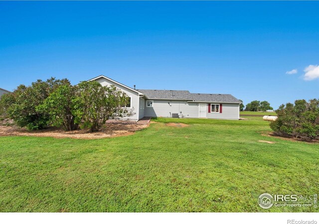 32924 County Road 29, Greeley, CO 80631 - rear view of property featuring a lawn