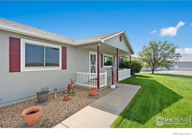 32924 County Road 29, Greeley, CO 80631 - doorway to property with a porch, a lawn, and roof with shingles