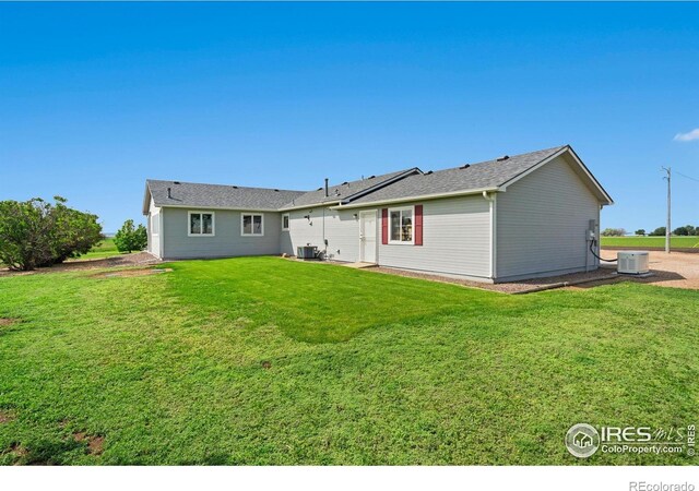 32924 County Road 29, Greeley, CO 80631 - back of property with a lawn and central AC unit
