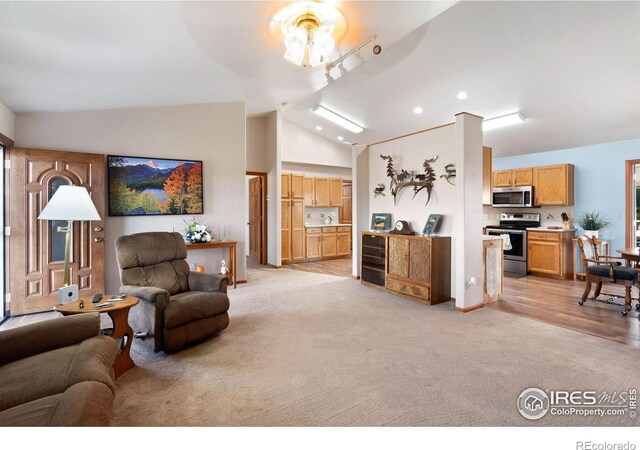 32924 County Road 29, Greeley, CO 80631 - living room with light carpet, lofted ceiling, ceiling fan, and recessed lighting