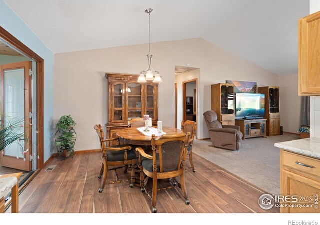32924 County Road 29, Greeley, CO 80631 - dining space with vaulted ceiling, light wood-style flooring, and baseboards