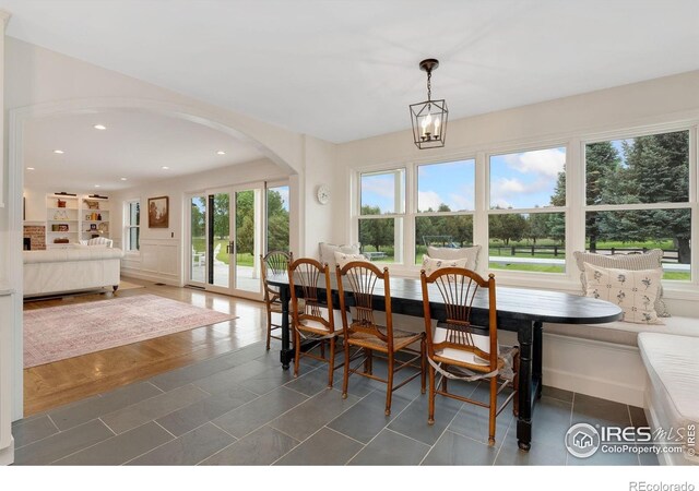 7215 Hygiene Rd, Longmont, CO 80503 - tiled dining room featuring arched walkways, recessed lighting, and built in features