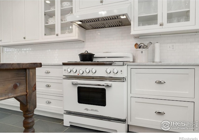 7215 Hygiene Rd, Longmont, CO 80503 - kitchen with white range with electric cooktop, custom exhaust hood, tasteful backsplash, light countertops, and white cabinetry