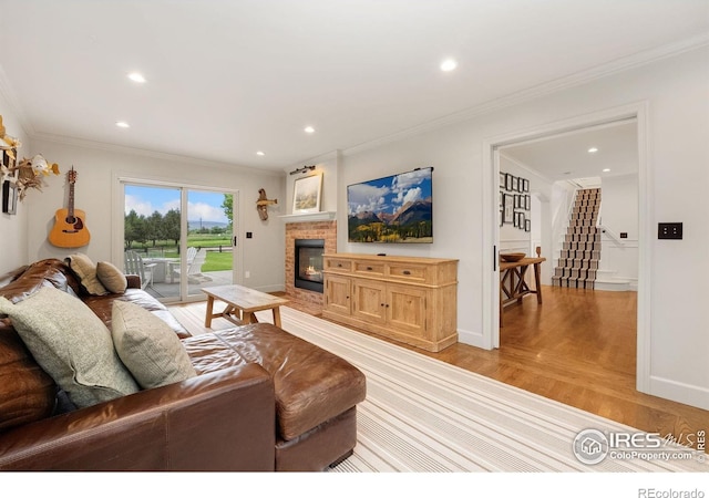 7215 Hygiene Rd, Longmont, CO 80503 - living area with light wood-style flooring, baseboards, recessed lighting, crown molding, and a glass covered fireplace