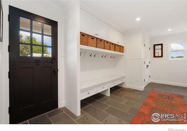 7215 Hygiene Rd, Longmont, CO 80503 - mudroom with healthy amount of natural light, a wainscoted wall, dark tile patterned flooring, crown molding, and recessed lighting