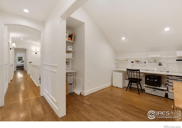 7215 Hygiene Rd, Longmont, CO 80503 - office featuring lofted ceiling, wood finished floors, arched walkways, recessed lighting, and baseboards