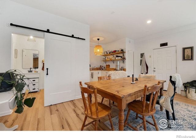 7215 Hygiene Rd, Longmont, CO 80503 - dining space featuring a barn door and light wood-style floors