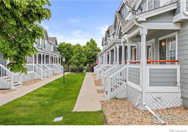3660 W 25th St Unit 1106, Greeley, CO 80634 - view of green lawn with covered porch and stairway