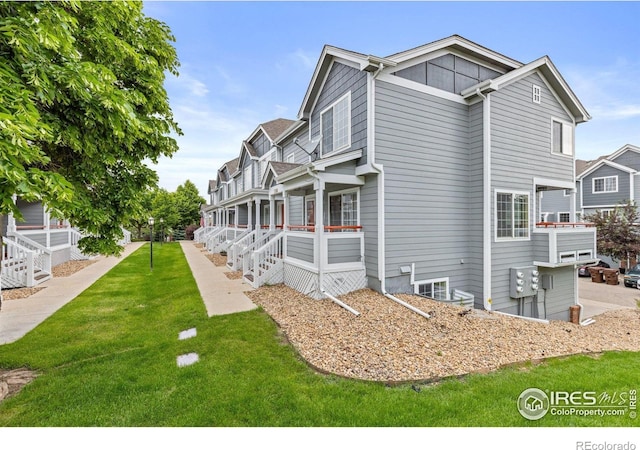 3660 W 25th St Unit 1106, Greeley, CO 80634 - view of side of home with a yard and covered porch