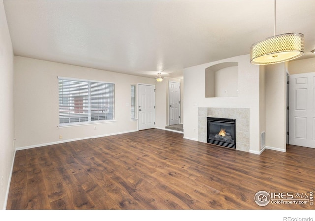 3660 W 25th St Unit 1106, Greeley, CO 80634 - unfurnished living room with wood finished floors, a fireplace, and baseboards