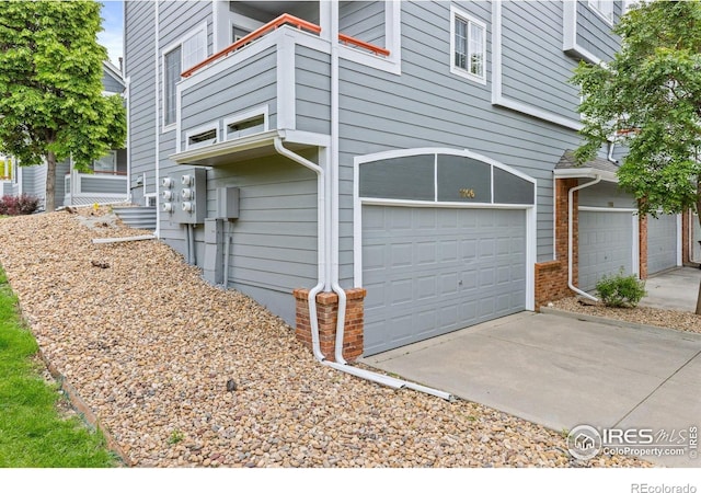 3660 W 25th St Unit 1106, Greeley, CO 80634 - view of property exterior featuring an attached garage and concrete driveway