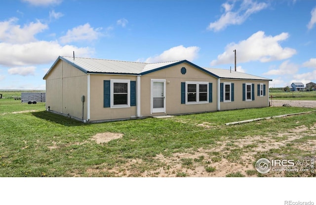 39780 County Road 68, Briggsdale, CO 80611 - ranch-style home with metal roof and a front lawn