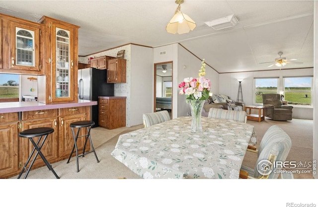39780 County Road 68, Briggsdale, CO 80611 - dining area featuring light colored carpet, ceiling fan, lofted ceiling, and crown molding