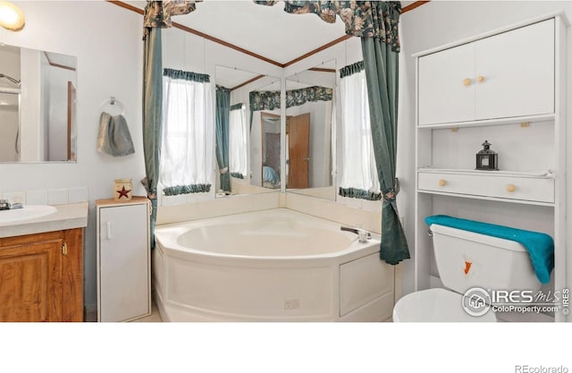 39780 County Road 68, Briggsdale, CO 80611 - bathroom featuring a garden tub, vanity, toilet, and crown molding