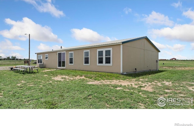 39780 County Road 68, Briggsdale, CO 80611 - back of house with a lawn and central air condition unit