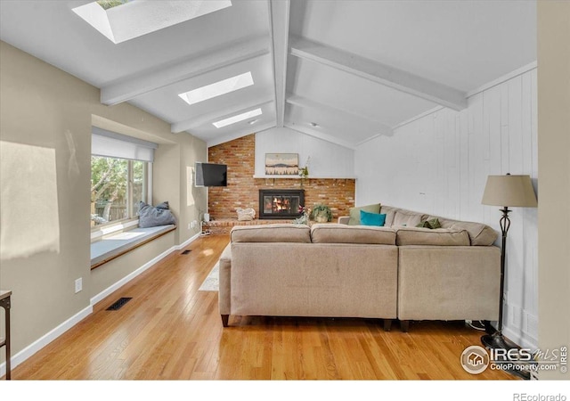 11290 Ranch Pl, Denver, CO 80234 - living area featuring a skylight, a brick fireplace, light wood-style floors, and baseboards
