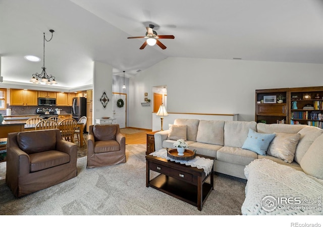 2325 Birdie Way, Milliken, CO 80543 - living area featuring a ceiling fan, vaulted ceiling, and a chandelier