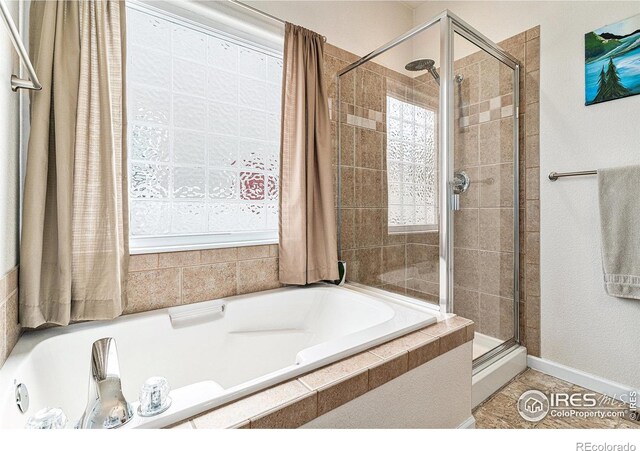 264 Alder Ave, Johnstown, CO 80534 - bathroom featuring a shower stall, a bath, and tile patterned flooring