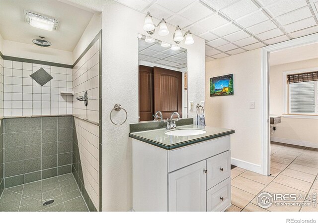 264 Alder Ave, Johnstown, CO 80534 - full bathroom with tile patterned floors, a tile shower, and vanity