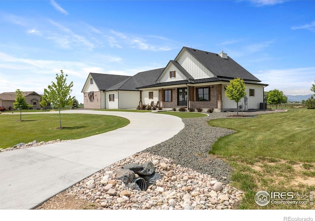 37179 Soaring Eagle Cir, Severance, CO 80550 - modern farmhouse with curved driveway, a front lawn, cooling unit, and brick siding
