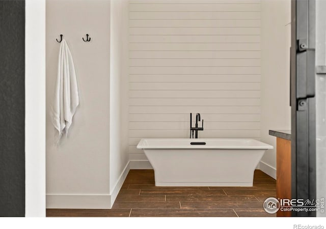 37179 Soaring Eagle Cir, Severance, CO 80550 - full bath featuring wood finished floors, a soaking tub, and baseboards