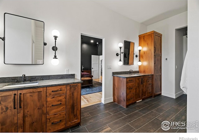 37179 Soaring Eagle Cir, Severance, CO 80550 - ensuite bathroom with wood tiled floors, two vanities, and baseboards