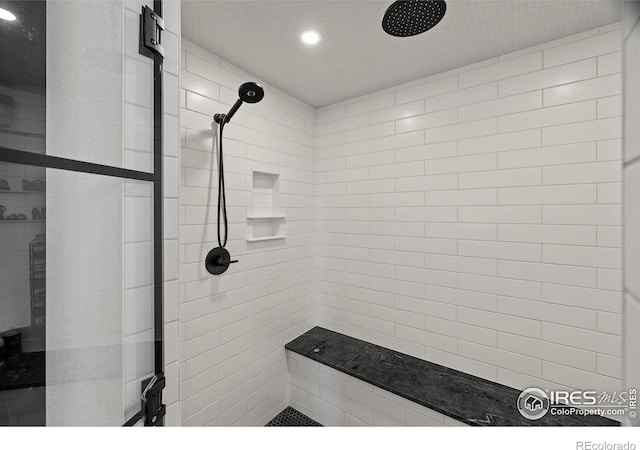 37179 Soaring Eagle Cir, Severance, CO 80550 - bathroom featuring tiled shower and recessed lighting