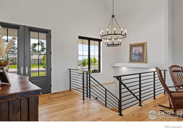37179 Soaring Eagle Cir, Severance, CO 80550 - stairs featuring plenty of natural light, a chandelier, wood finished floors, french doors, and a high ceiling