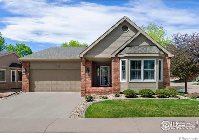 1142 Muirfield Way, Fort Collins, CO 80525 - view of front facade featuring brick siding, an attached garage, and driveway