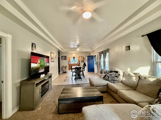 541 S Phelan Ave, Holyoke, CO 80734 - living room featuring a ceiling fan, plenty of natural light, and a tray ceiling