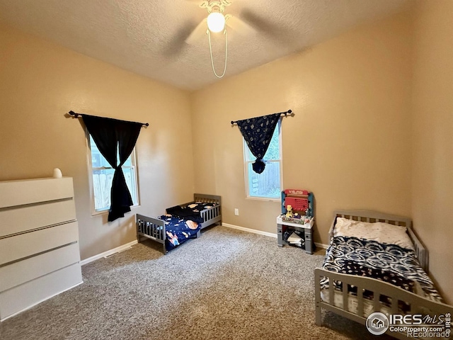 541 S Phelan Ave, Holyoke, CO 80734 - bedroom with a textured ceiling, carpet, and ceiling fan