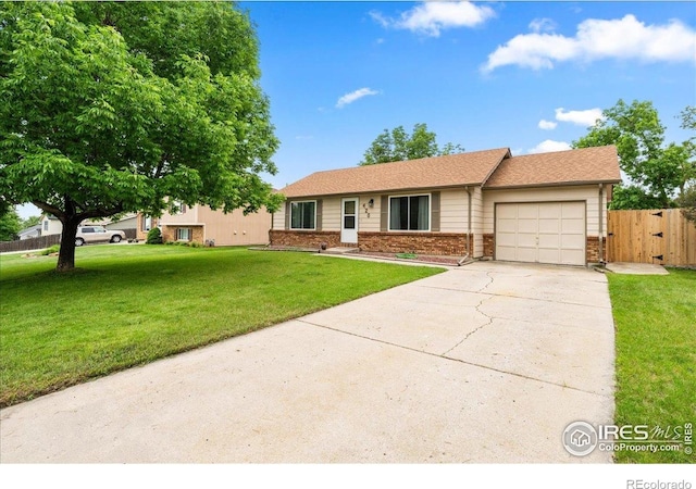 420 E 50th St, Loveland, CO 80538 - ranch-style home featuring a garage, driveway, and brick siding