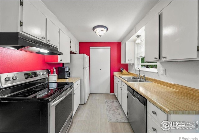 420 E 50th St, Loveland, CO 80538 - kitchen featuring appliances with stainless steel finishes, under cabinet range hood, a sink, and light countertops