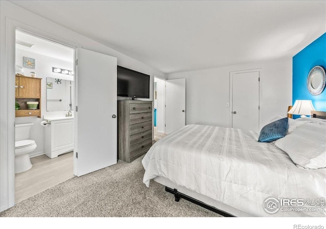 420 E 50th St, Loveland, CO 80538 - bedroom featuring ensuite bathroom and light colored carpet