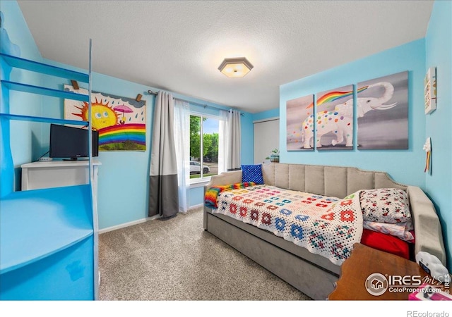 420 E 50th St, Loveland, CO 80538 - bedroom with carpet, a textured ceiling, and baseboards
