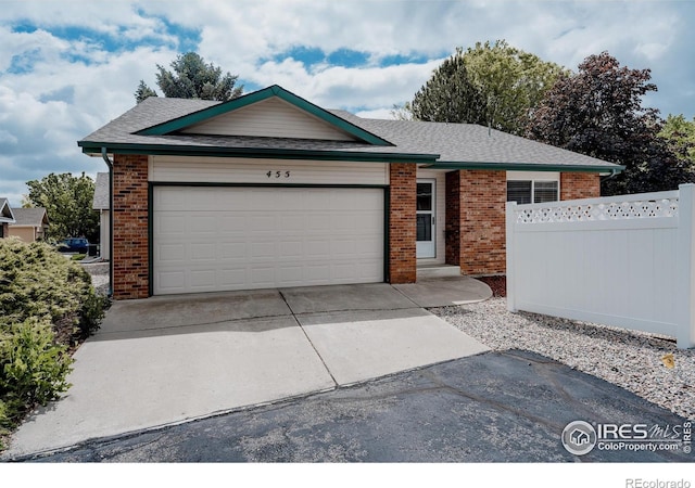 455 Radiant Dr, Loveland, CO 80538 - ranch-style home with brick siding, driveway, a garage, and a shingled roof