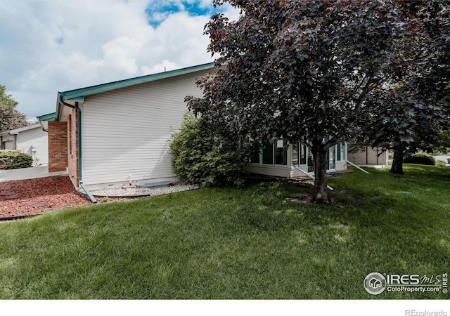 455 Radiant Dr, Loveland, CO 80538 - view of side of home with a lawn
