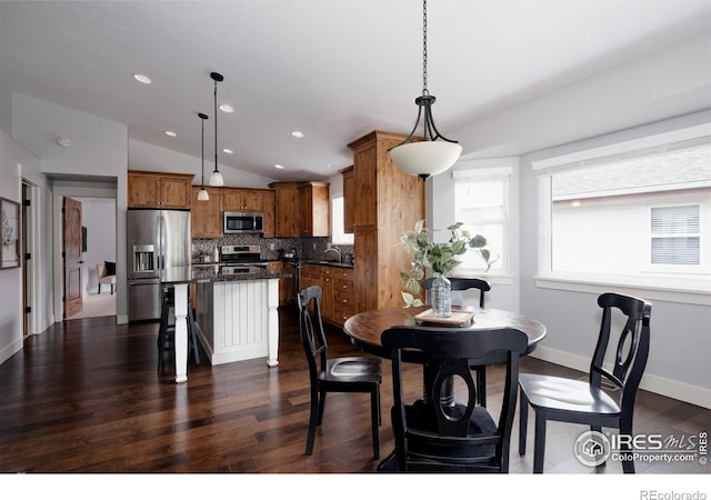 455 Radiant Dr, Loveland, CO 80538 - dining space with vaulted ceiling, dark wood-style floors, recessed lighting, and baseboards