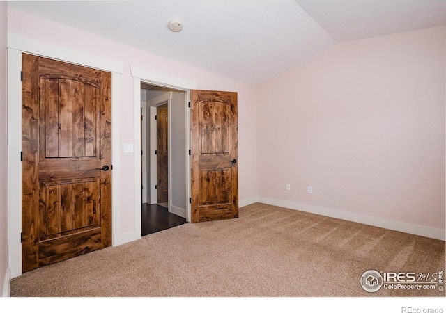 455 Radiant Dr, Loveland, CO 80538 - carpeted bedroom featuring vaulted ceiling and baseboards